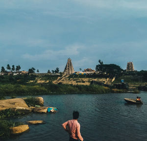 Rear view of man and woman in lake