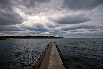 Pier over sea against sky