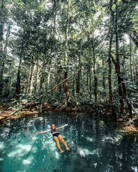 Man swimming in forest