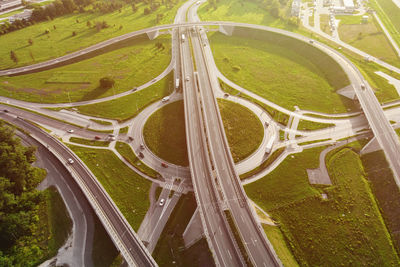 Cars moving on transport road junction in city, aerial view