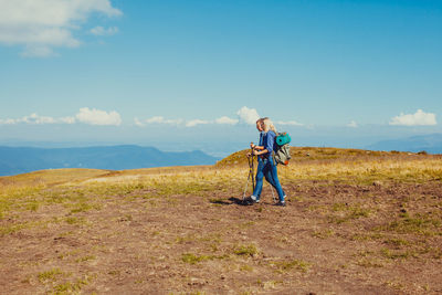 Man standing on field against sky