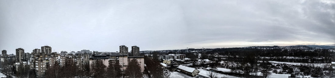 Panoramic view of buildings against sky during winter