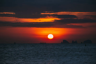 Scenic view of sea against orange sky