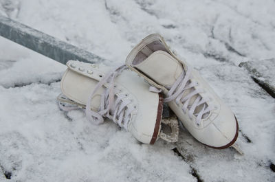 High angle view of ice skates on boardwalk during winter