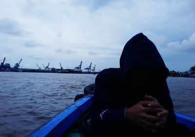 Portrait of man in boat against sky