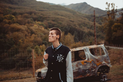 Portrait of smiling young man standing on land