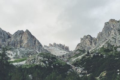 View of rocky mountain against cloudy sky