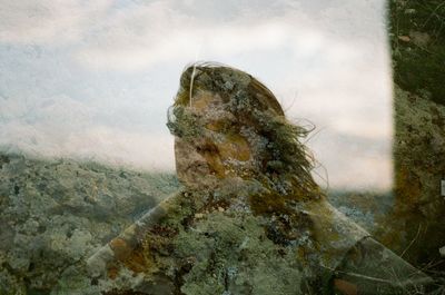 Double exposure of young woman and mountain
