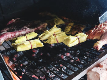 High angle view of meat on barbecue grill