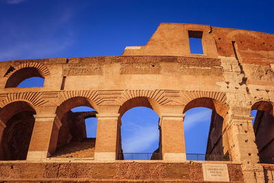 Low angle view of historical building against blue sky