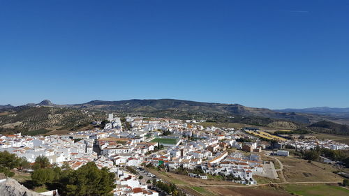 High angle view of townscape against blue sky