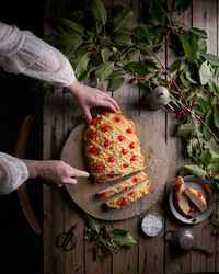 Directly above shot of person holding fruits on table