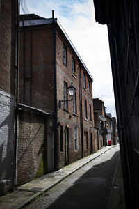 Empty road along buildings