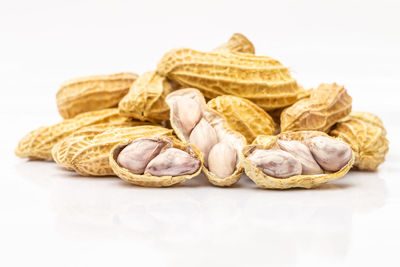 Close-up of bread on table against white background