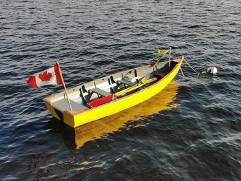 High angle view of yellow boat sailing in sea