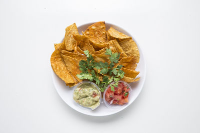 High angle view of food in plate against white background