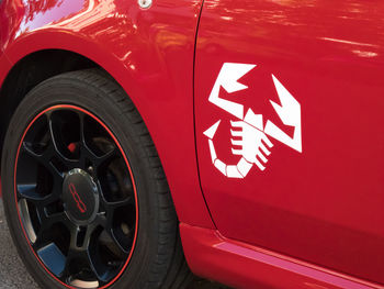 Close-up of red car on road