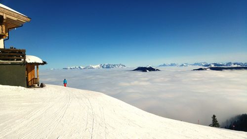 Person skiing on mountain against sky