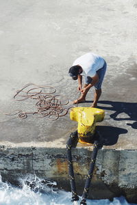 Man working on seashore