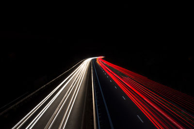 High angle view of light trails on road at night