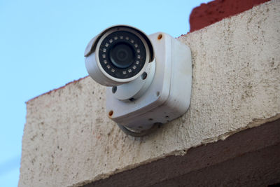 Low angle view of camera on wall