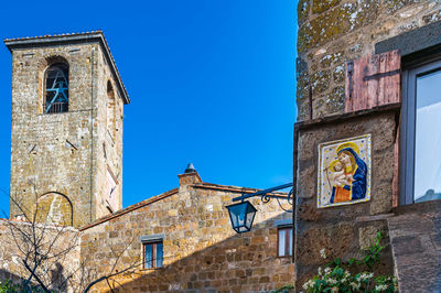 Low angle view of old building against clear blue sky