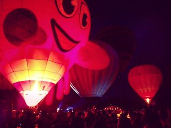 Rear view of people enjoying music concert at night