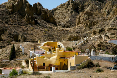 Scenic view of trees and buildings against mountain