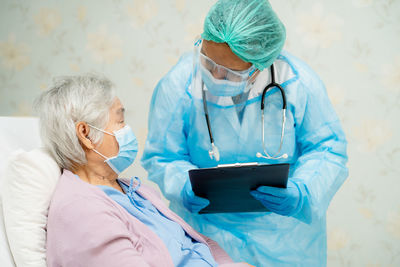 Doctor talking with patient in hospital