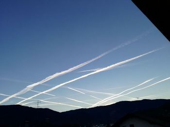 Low angle view of vapor trails in sky