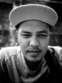 Close-up portrait of young man wearing cap