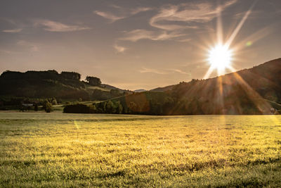 Scenic view of field against sky during sunset