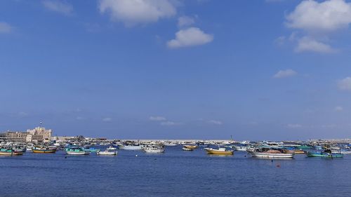 Boats in sea against sky