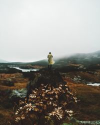 Man standing on field against sky