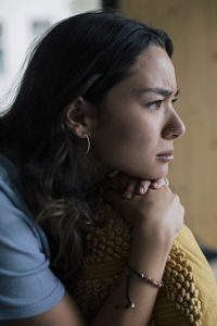 Worried woman contemplating at home