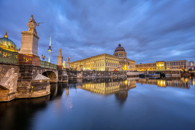 The reconstructed berlin city palace with the television tower at twilight