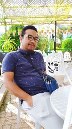 Portrait of young man sitting outdoors