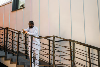 Low angle view of woman standing on staircase