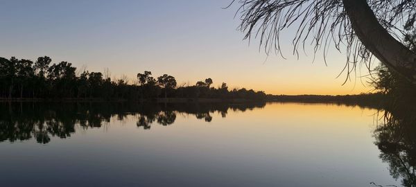 Scenic view of lake against sky during sunset