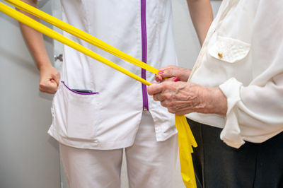 Midsection of couple holding hands