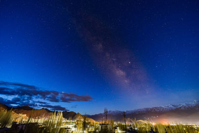 Scenic view of illuminated mountain against sky at night