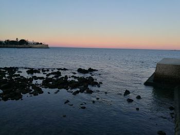 Scenic view of sea against sky at sunset