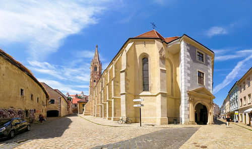 Street amidst buildings against sky in city