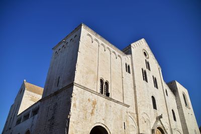 Low angle view of building against clear blue sky