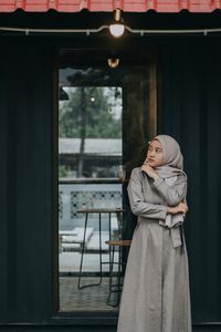 Woman standing against entrance