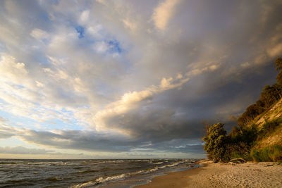 Scenic view of beach against sky during sunset