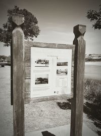 Information sign against sky