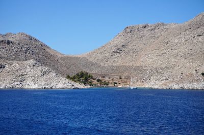 Scenic view of mountains against clear blue sky