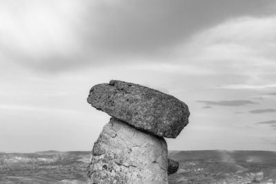 Close-up of fairy chimneys rock by sea against sky