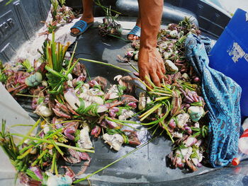 Low section of man holding food at market